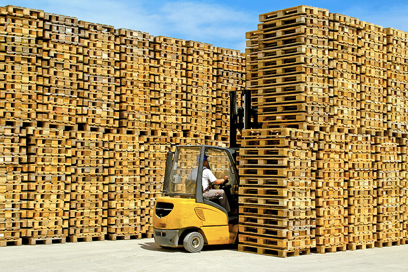 Forklift Picking Up Pallet Stack - Texas Pallets LLC